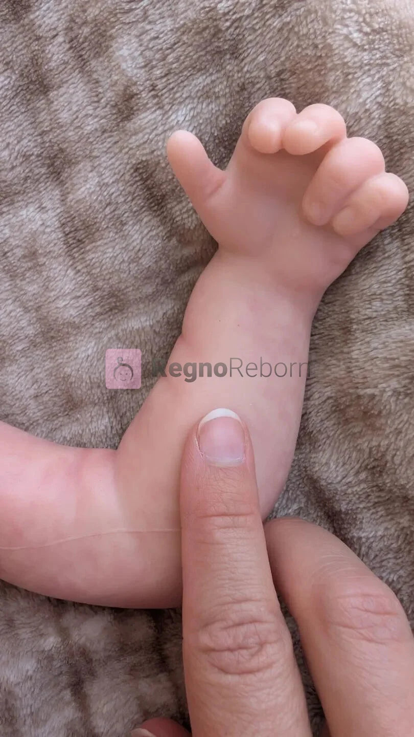 Dettaglio della mano e delle pieghe della pelle del neonato che sembra vero